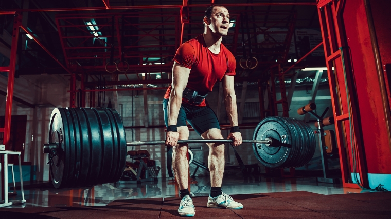 A person holding a heavy barbell.