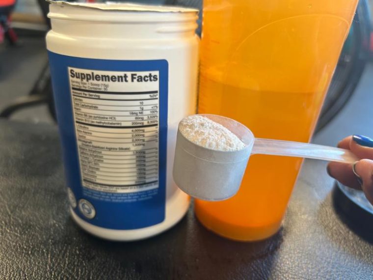 Person holding a scoop of Nutricost Pre-X